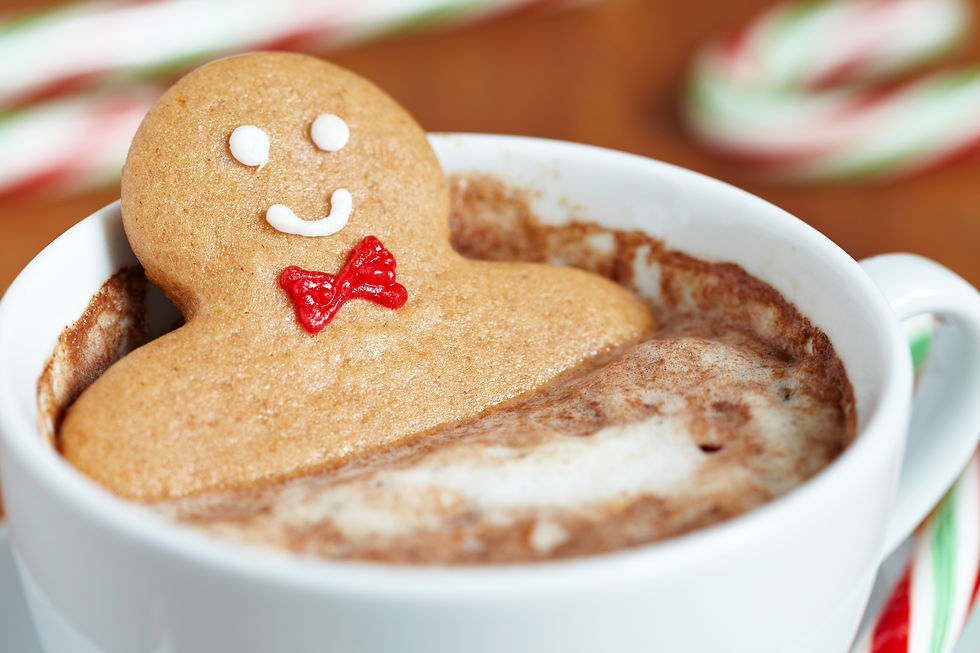 A gingerbread man relaxing in a cup of hot cocoa