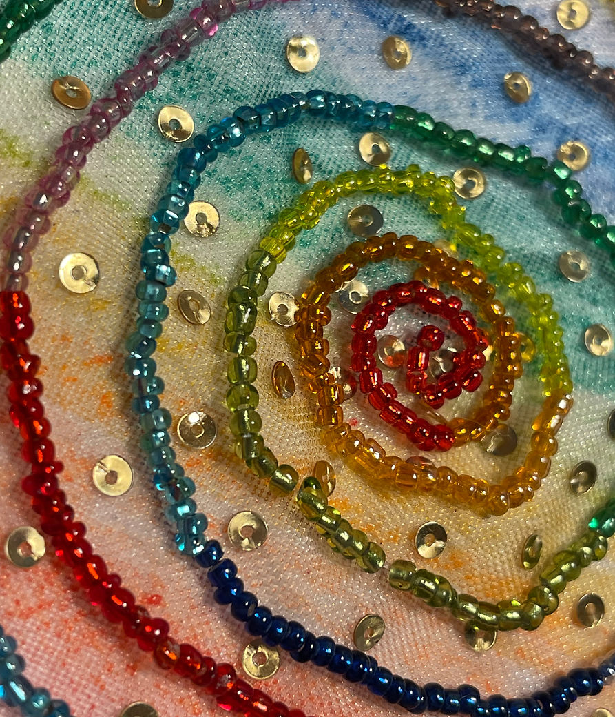 Pangea Kali Virga Miami artist beading and embroidery detail of a rainbow spiral with gold sequins.