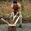 Thumbnail: Rugged man chopping wood wearing the mossy coast rock stamped mountain hoodie