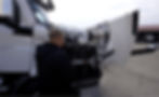 Guy looking at the engine of a truck