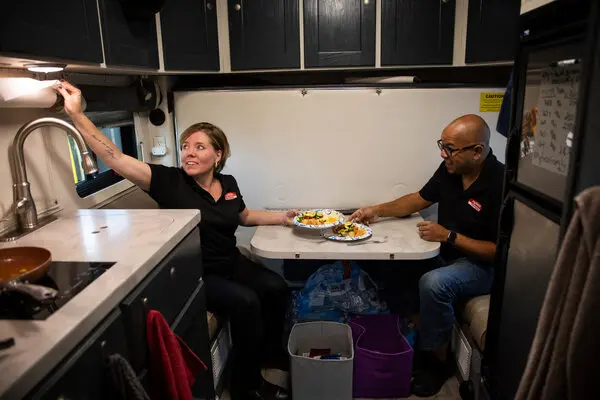 Two people eating inside a semi truck