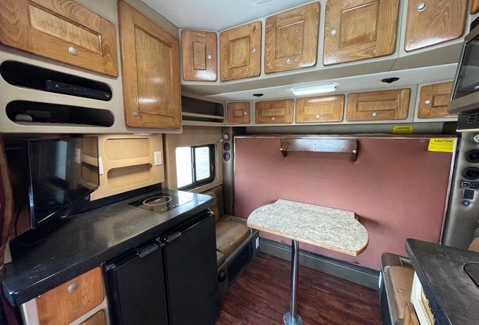 Passenger side view of inside the sleeper with the bed in an upright position