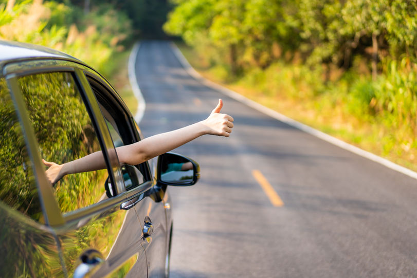 Woman in the car showing her thumb up sign.jpeg