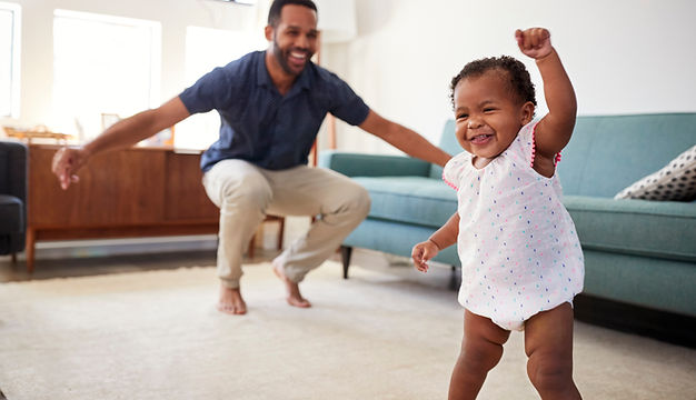 Baby Daughter Dancing With Father At Home.jpeg