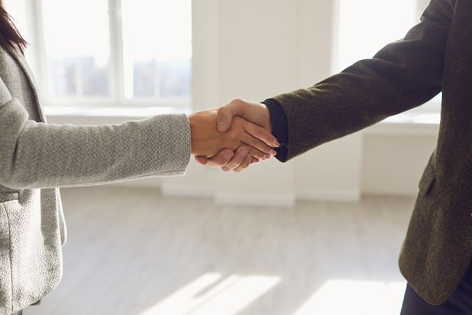Handshake of businesspeople male female.jpeg
