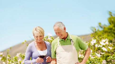 older couple grilling outside