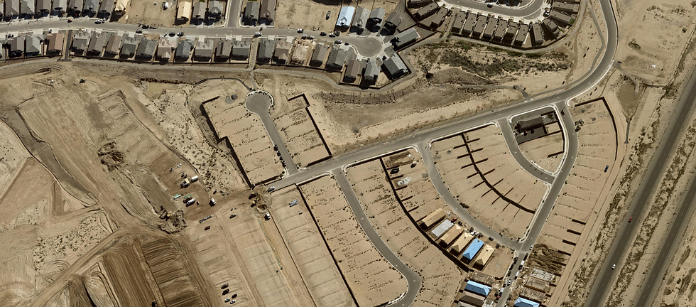 Aerial view of the Fiesta del Norte subdivision by D.R. Horton captures the community at a distinct moment of transition — completed and occupied single-family homes in the upper frame giving way to a dense field of freshly platted, graded lots in active build-out. Infrastructure installation is visibly underway in the lower quadrant, with construction equipment on-site and curb-and-gutter street networks already in place awaiting vertical starts. The lot configuration — uniform pad sizes, curved collector streets, and cul-de-sac fingers consistent with conventional master-planned residential design — suggests several hundred additional units in the immediate pipeline. This community sits approximately three to four miles northeast of the Meta data center campus, illustrating the direct residential demand response catalyzed by large-scale industrial investment in Valencia County. Photo taken November 7, 2025. Source: MMCG Invest, LLC / EagleView