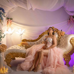 Motherhood maternity session with flowers and elegant lounge seating