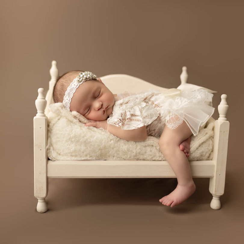 newborn baby sleeping on tiny bed during Orlando newborn photography session