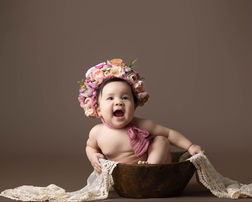 Six-month-old baby girl wearing a floral headpiece during a milestone photography session in Orlando.