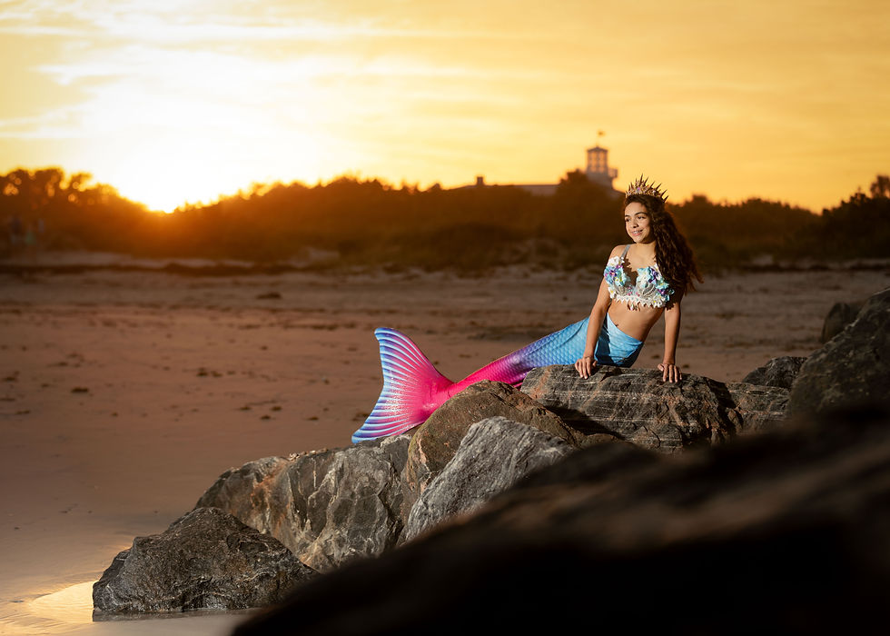 Birthday mermaid photoshoot at Port Canaveral featuring a 12-year-old girl posing by the ocean and coastal rocks.
