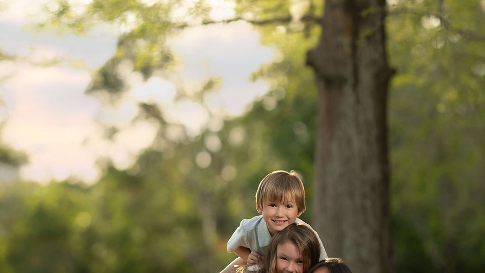 Emotional connection between a father, mother and her kids during a lakeside sunset photoshoot in Oviedo Florida