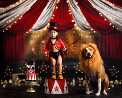 Two-year-old baby dressed as a ringmaster during a circus-themed cake smash session in an Orlando photography studio.