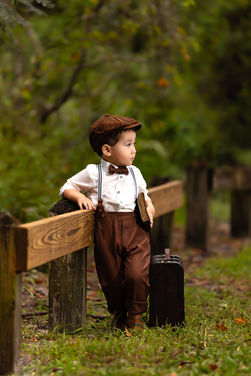 Three-year-old boy posing in an outdoor vintage-style portrait session in Orlando.