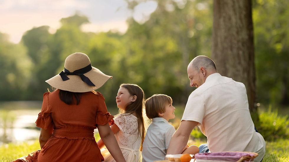 Beautiful family relaxing together on a picnic blanket near a lake at sunset in Orlando outdoor photoshoot