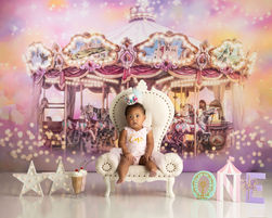 One-year-old baby posing in a carousel-themed cake smash session with pastel colors in Orlando studio.