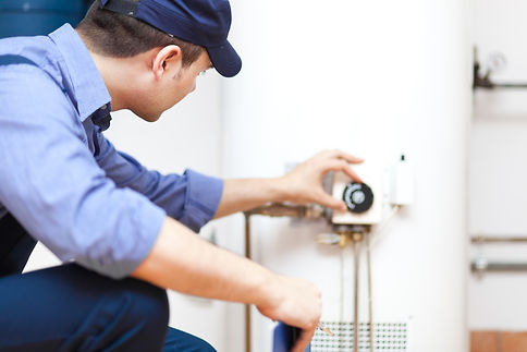 Plumber repairing an hot-water heater.jp