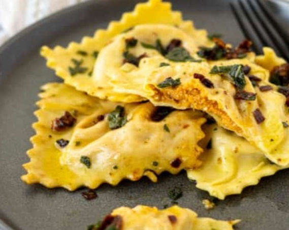 Pumpkin Ravioli with Braised Pear Sauce & Guanciale Garnish