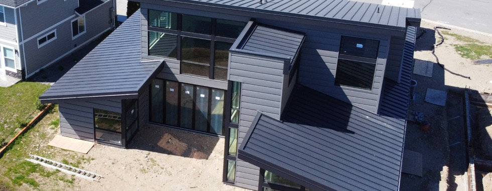 Exterior aerial view of a modern, H-shaped single-family residence in Brewster, WA by modFORM llc.
