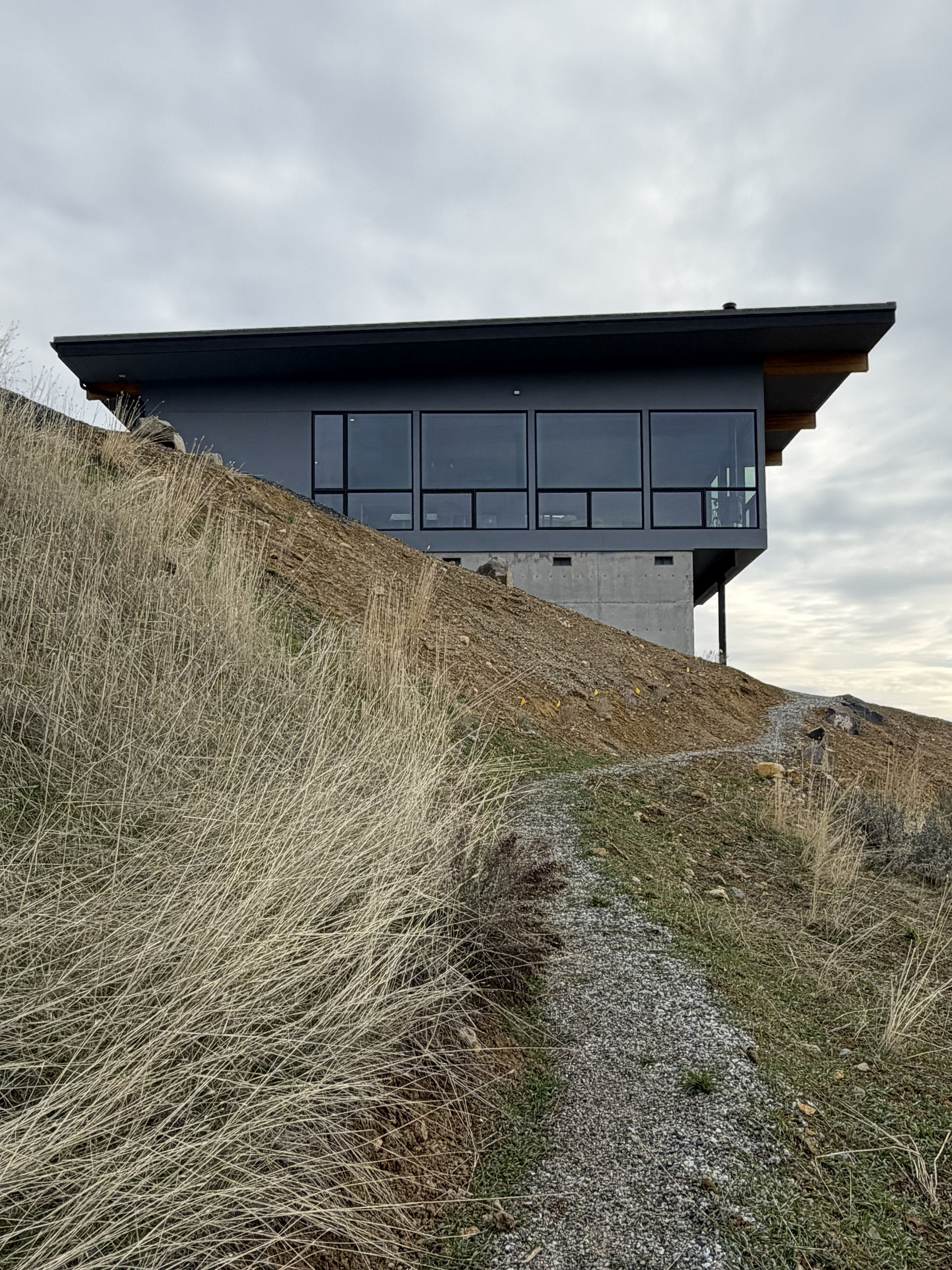 Exterior side view of a modern v-shaped single-family residence in Wenatchee, WA by modFORM LLC.