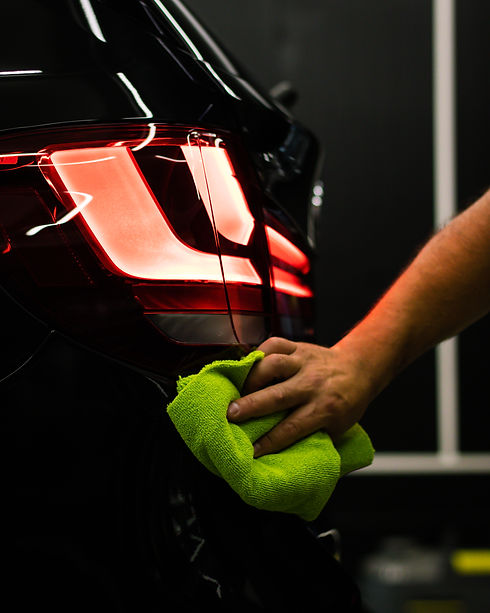 selective-focus-shot-man-cleaning-car-s-back-headlight-with-microfiber-cloth.jpg