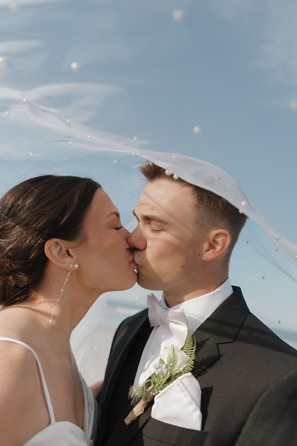 Bride and groom celebrating after their beach ceremony in Corolla, NC