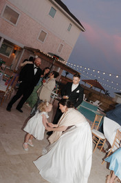 Wedding guests dancing under string lights at an Outer Banks wedding
