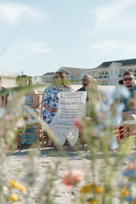 Guests watching a beach wedding ceremony on the Outer Banks shoreline