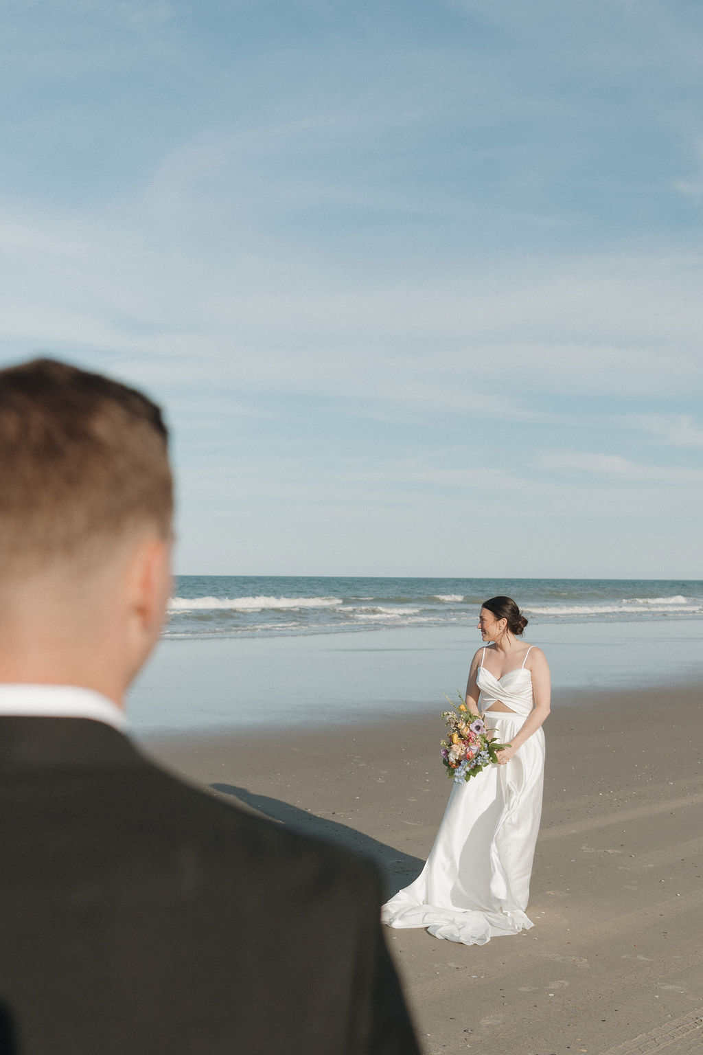 Bride and groom walking along the beach during their Corolla 4x4 beach destination wedding in the Outer Banks