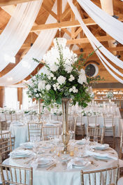 wedding/reception/with/white/florals/and/greenery