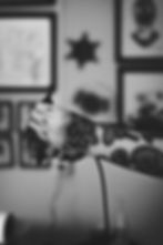 Tattoo artist holding machine with bold rose and skull tattoos on arm at Dreamline Tattoo Studio Bali