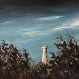 A white, conical lighthouse visible agains a blue sky through a break in the brush along a windy coast.