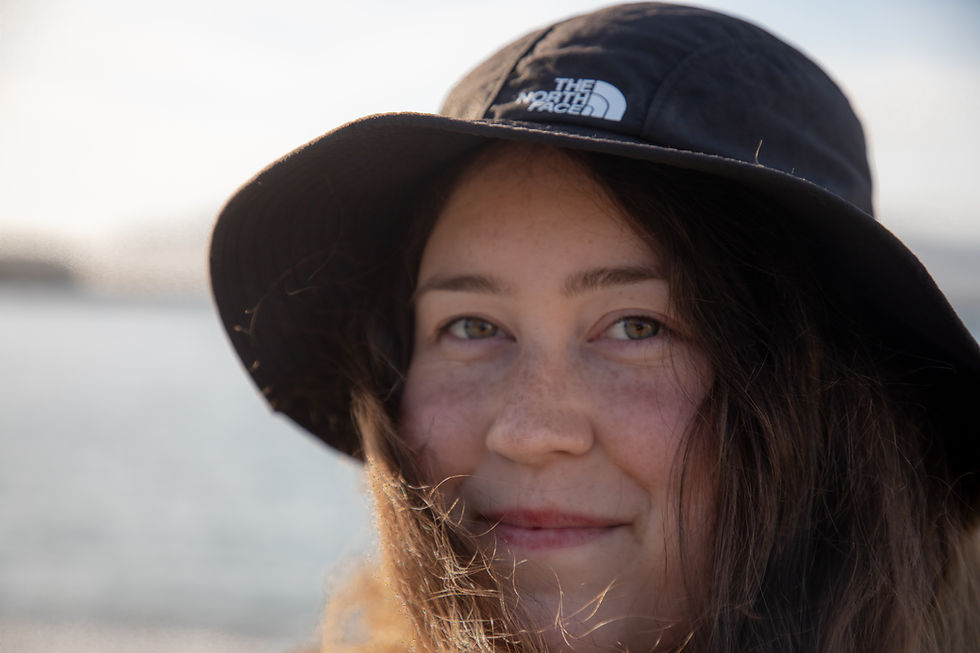 North Face bucket hat on womans face in the sun