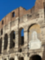 Rome Italy, A close up of the Colosseum in Rome shows ancient text and a cross on the aged world wonder