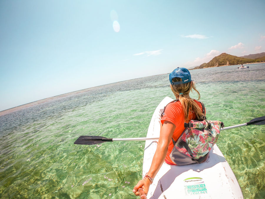 Woman kayaking in clear water at Grand Grossier sandbar.