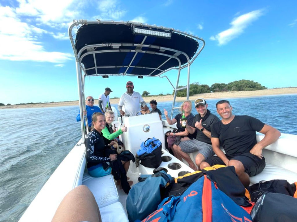 Tour group enjoying a boat ride on crystal-clear waters near Buen Hombre.
