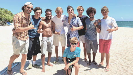 Group of young men smiling on a sunny Buen Hombre kite beach.