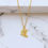 Thumbnail: Gold Chinese character which means path or road necklace on marble.