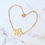 Thumbnail: gold cherry blossom bracelet on marble surface in heart shape.