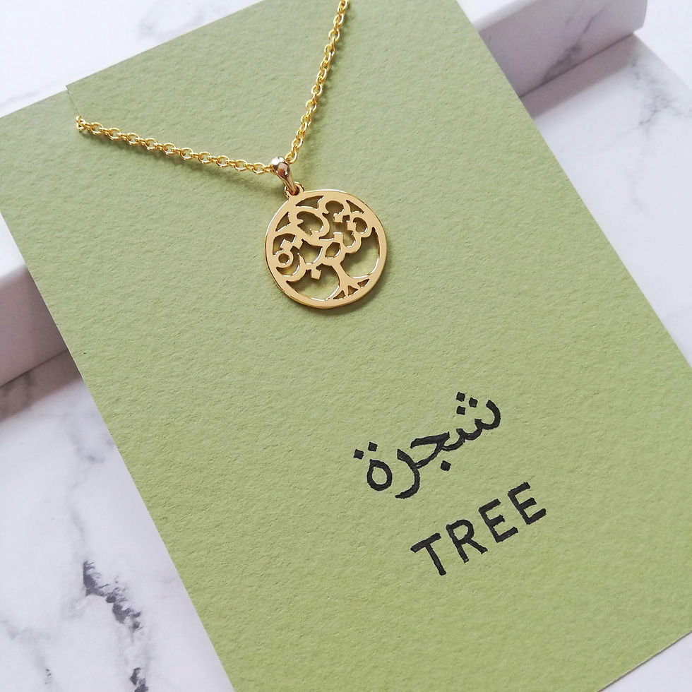 サムネイル： Gold color tree necklace designed with Arabic word on green card.