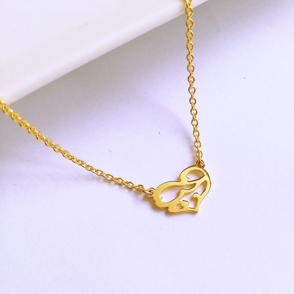 Thumbnail: Gold landscaped heart necklace. The hear shape is embedded with Arabic word that means love.