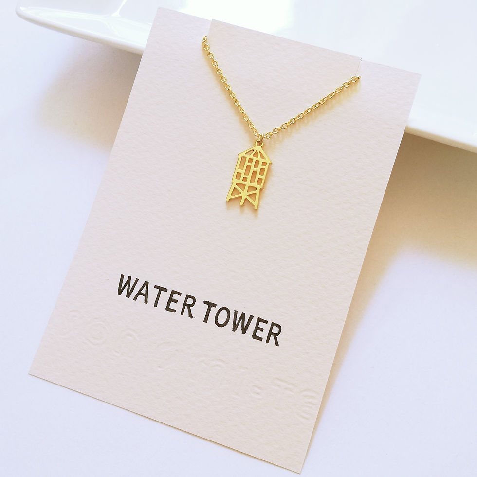 サムネイル： Gold small water tower necklace on pale pink card.