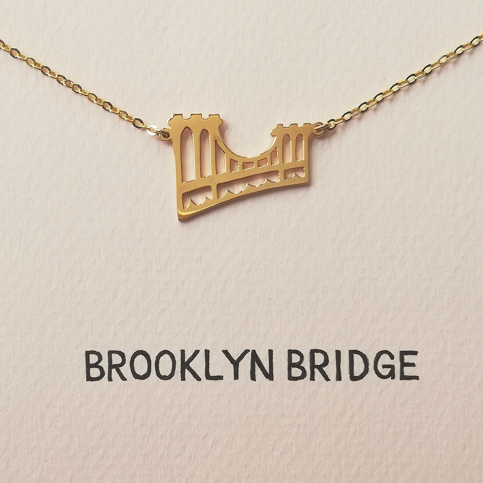 Thumbnail: Gold Brooklyn Bridge necklace set on pink card. The top is cutout and flat.