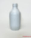 A glass bottle fully coated with white enamel paint, dried and ready for decoupage with vellum stickers