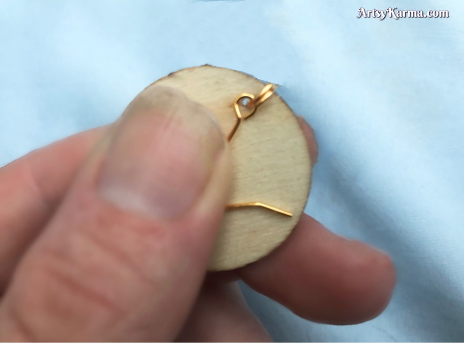 Attach a jump ring and earring hook to your decorated wood slab.