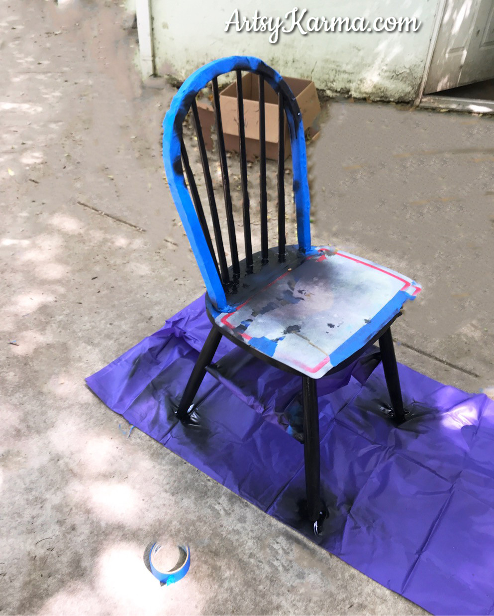 spray paint sections of chair black for makeover