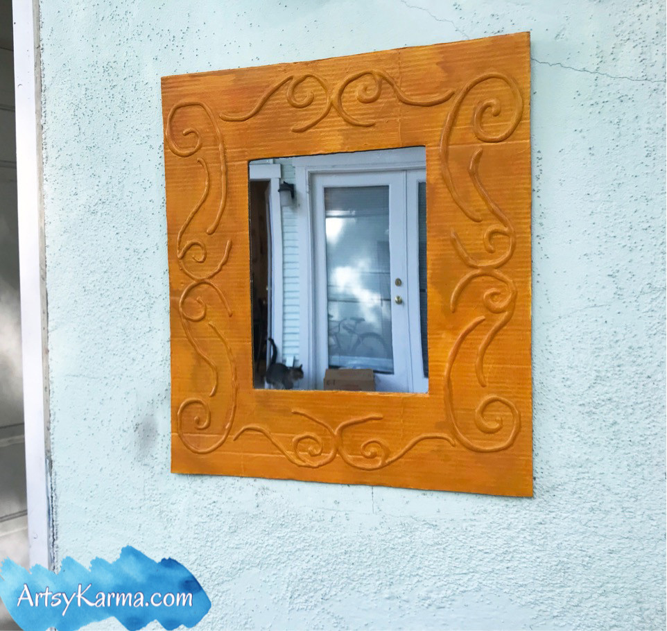 a beautiful faux embossed frame for a dollar store mirror