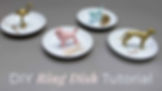 Set of white ceramic ring dishes topped with colorful painted animal figurines used as jewelry holders, including a flamingo, poodle, and greyhound.