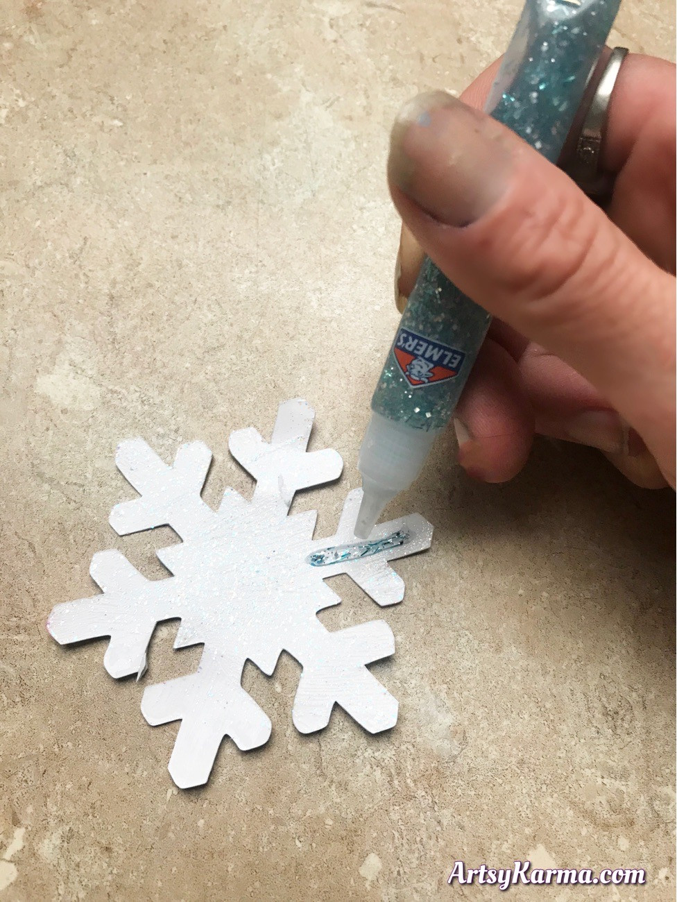 Add glitter glue to your cut out snowflakes