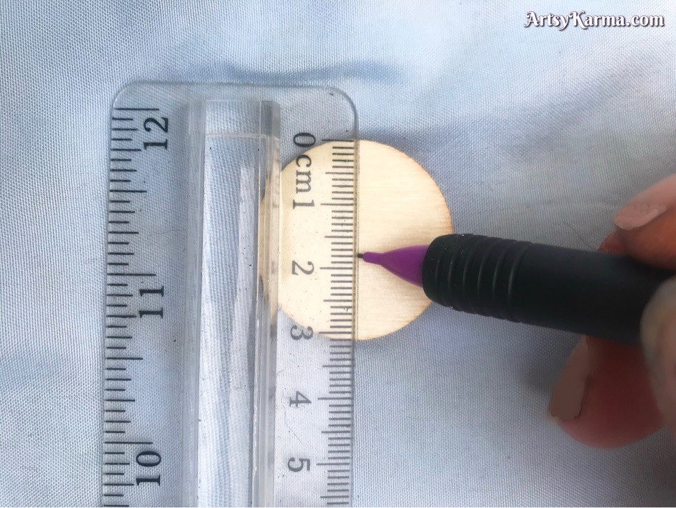 Measuring wood piece to decorate with mandala design